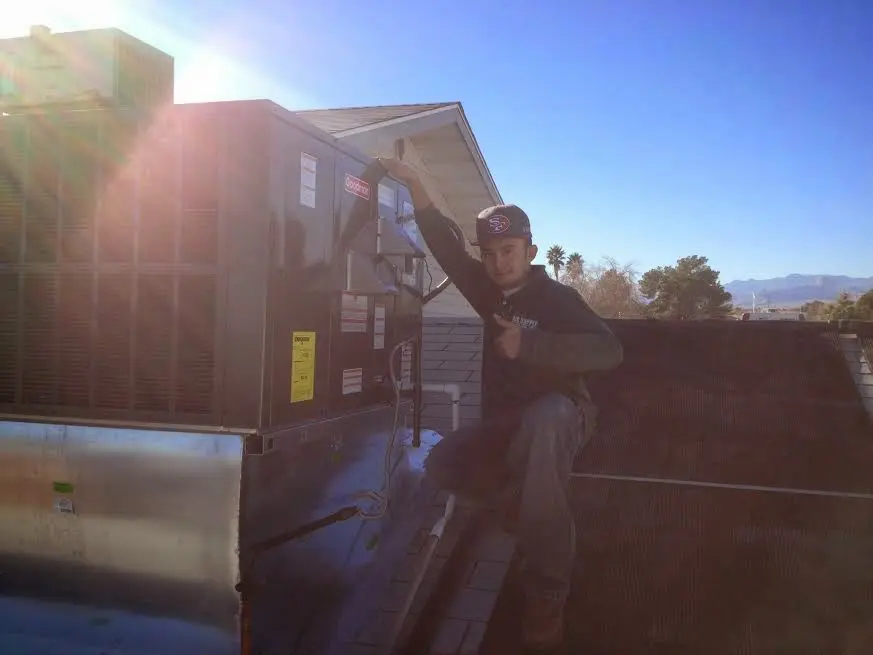 HVAC technician performing HVAC Inspection on a rooftop unit in Terrytown